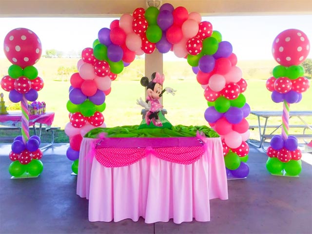 A table with pink and green decorations on it