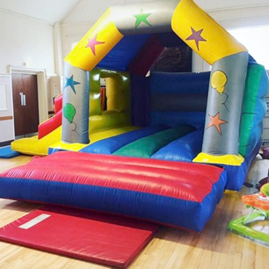 A bouncy castle with stars on it in the middle of a room.