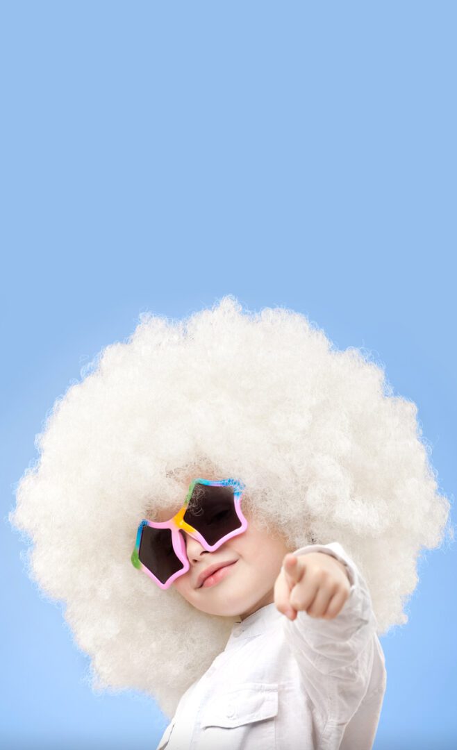 A person with white hair and sunglasses