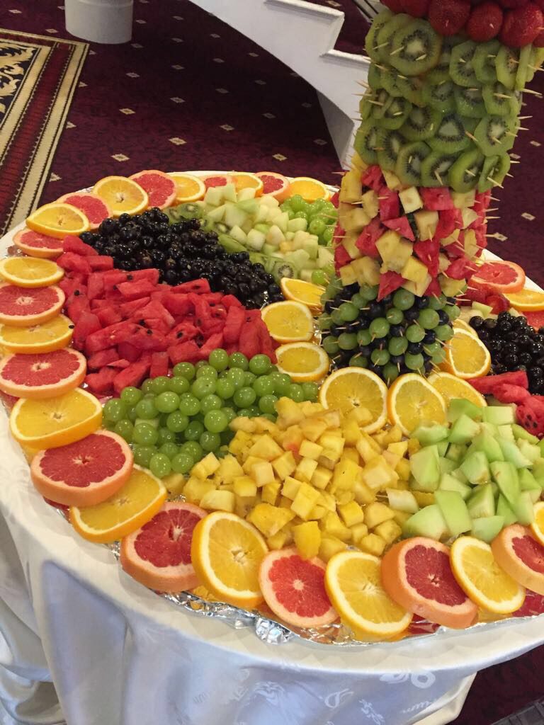 A platter of fruit is displayed on the table.