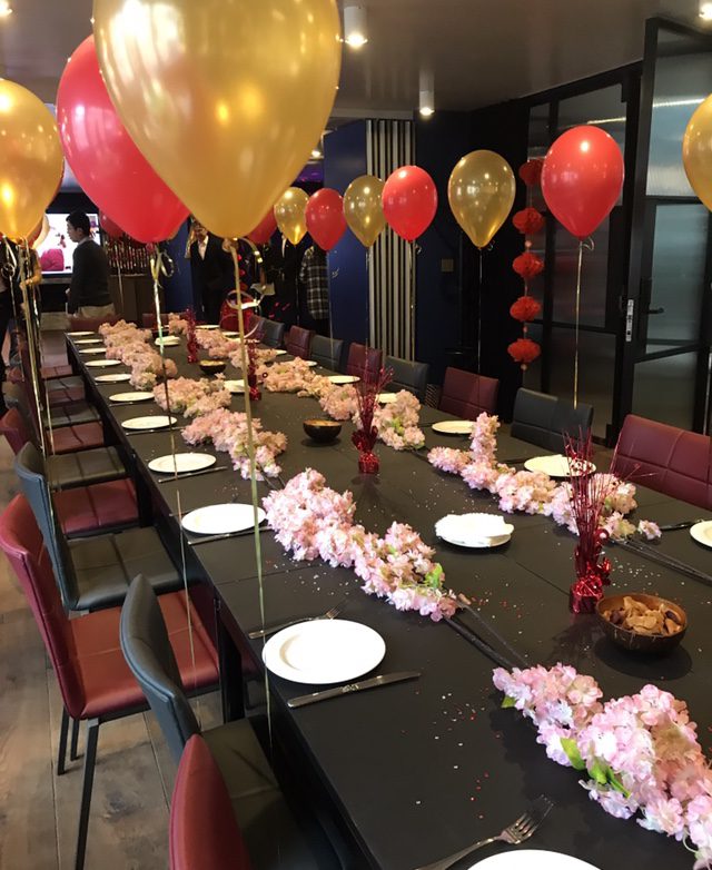 A long table with plates and flowers on it