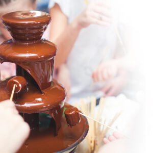 A chocolate fountain is being used to make chocolate.