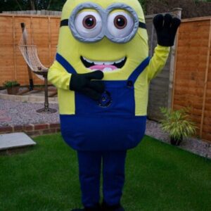 A person in a minion costume standing on the grass.