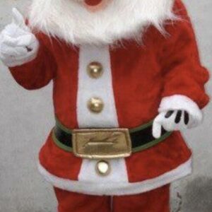 A person in santa clause costume standing next to wall.