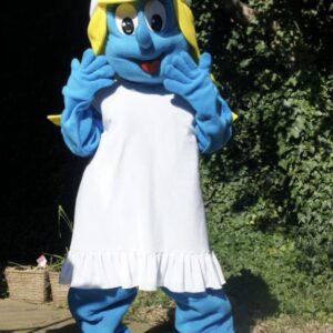 A person in smurf costume standing on the side of road.