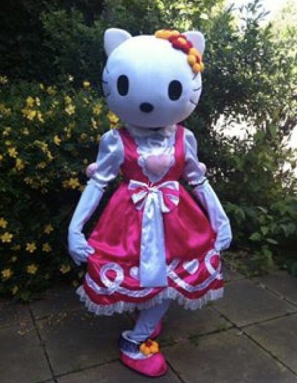 A hello kitty costume is shown in front of bushes.