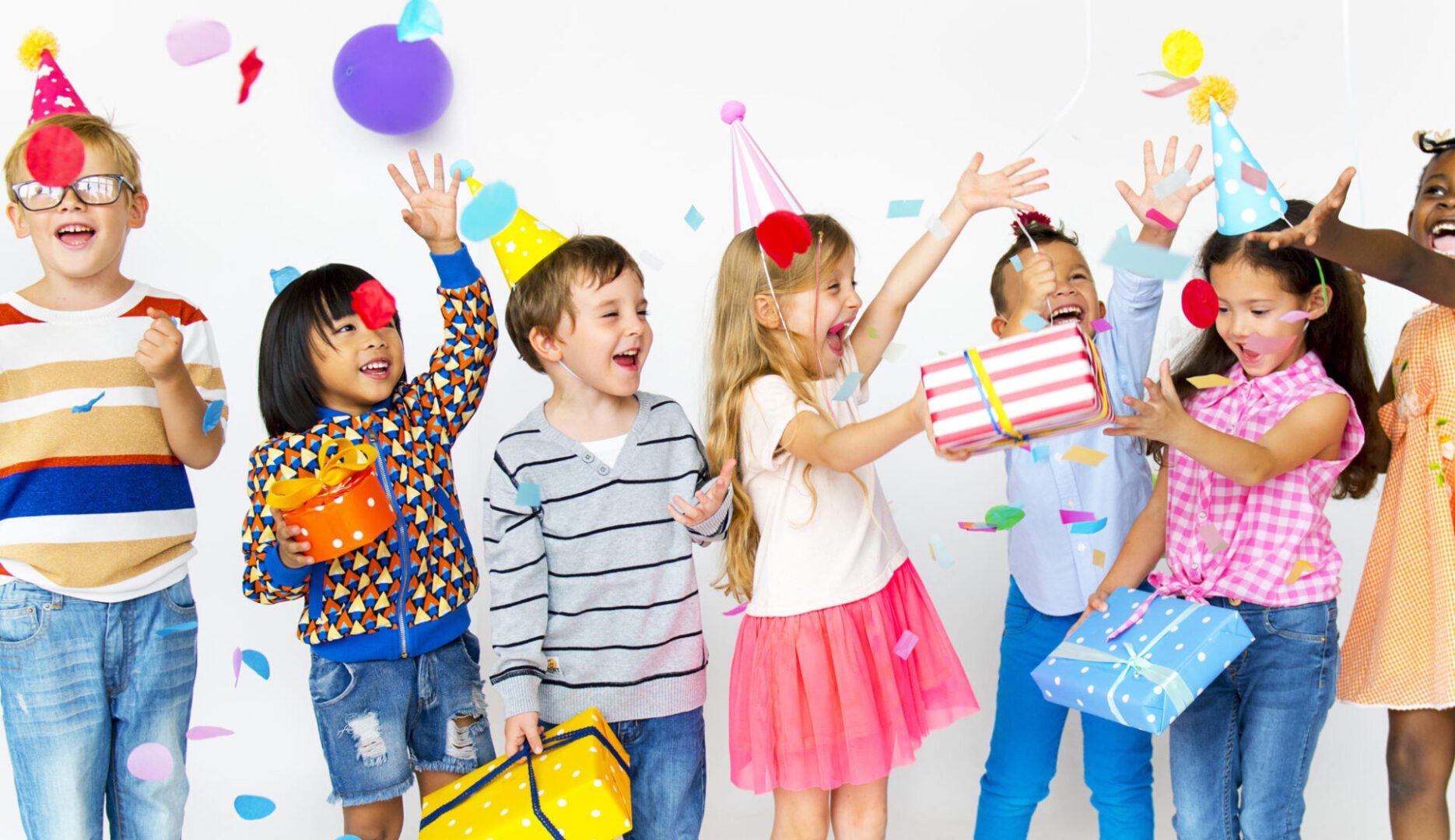 A group of kids with party hats and bags